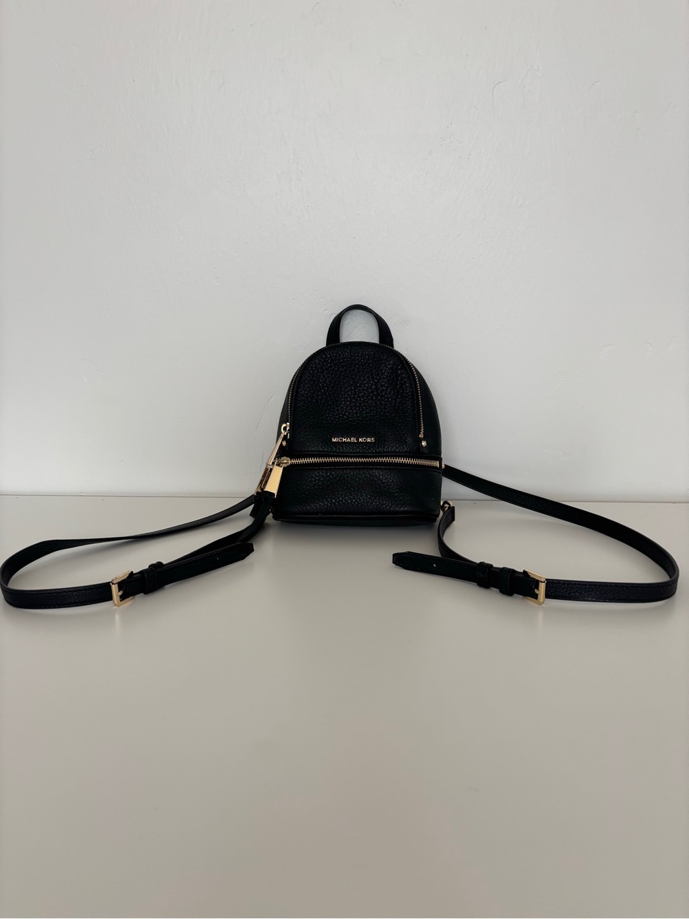 Black Michael Kors Rhea Mini Backpack with gold tone hardware
